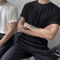 Men's solid color round neck cotton t-shirt in white or black with half sleeves and slim fit