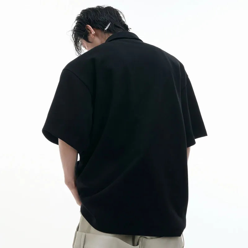 Men's black polo shirt with a grey geometric Giant Land Turtle print and a deconstructed shirt collar.