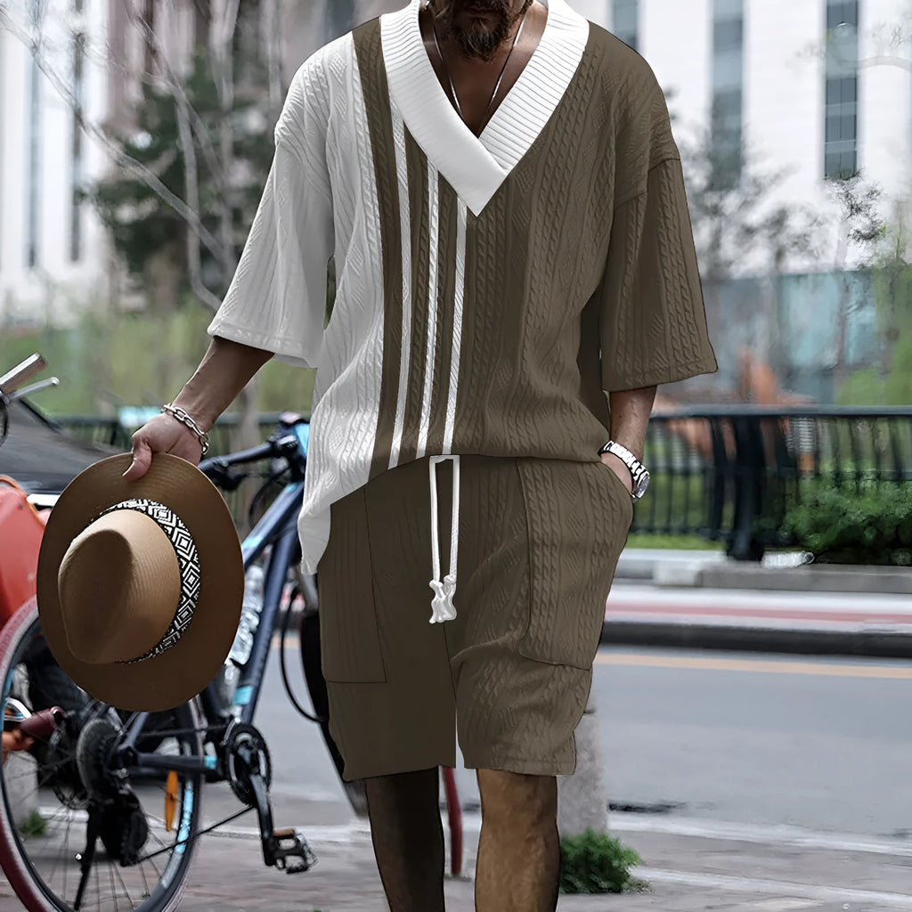 Man wearing a printed drop-shoulder knitted short-sleeve top with matching shorts, a casual loungewear set.