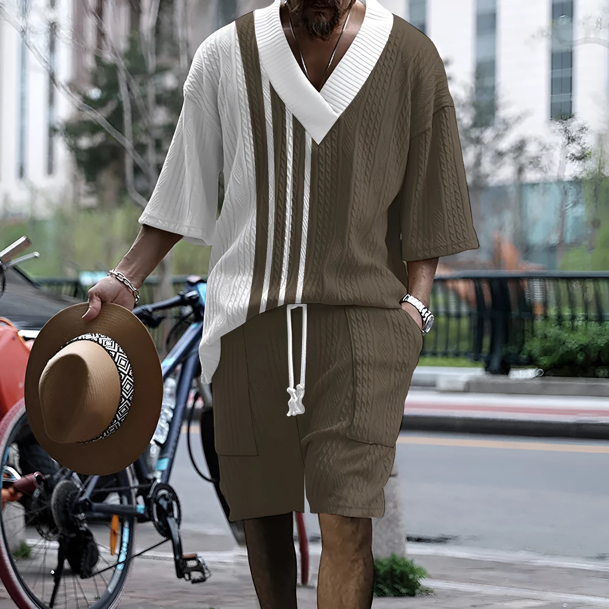 Man wearing a printed drop-shoulder knitted short-sleeve top with matching shorts, a casual loungewear set.