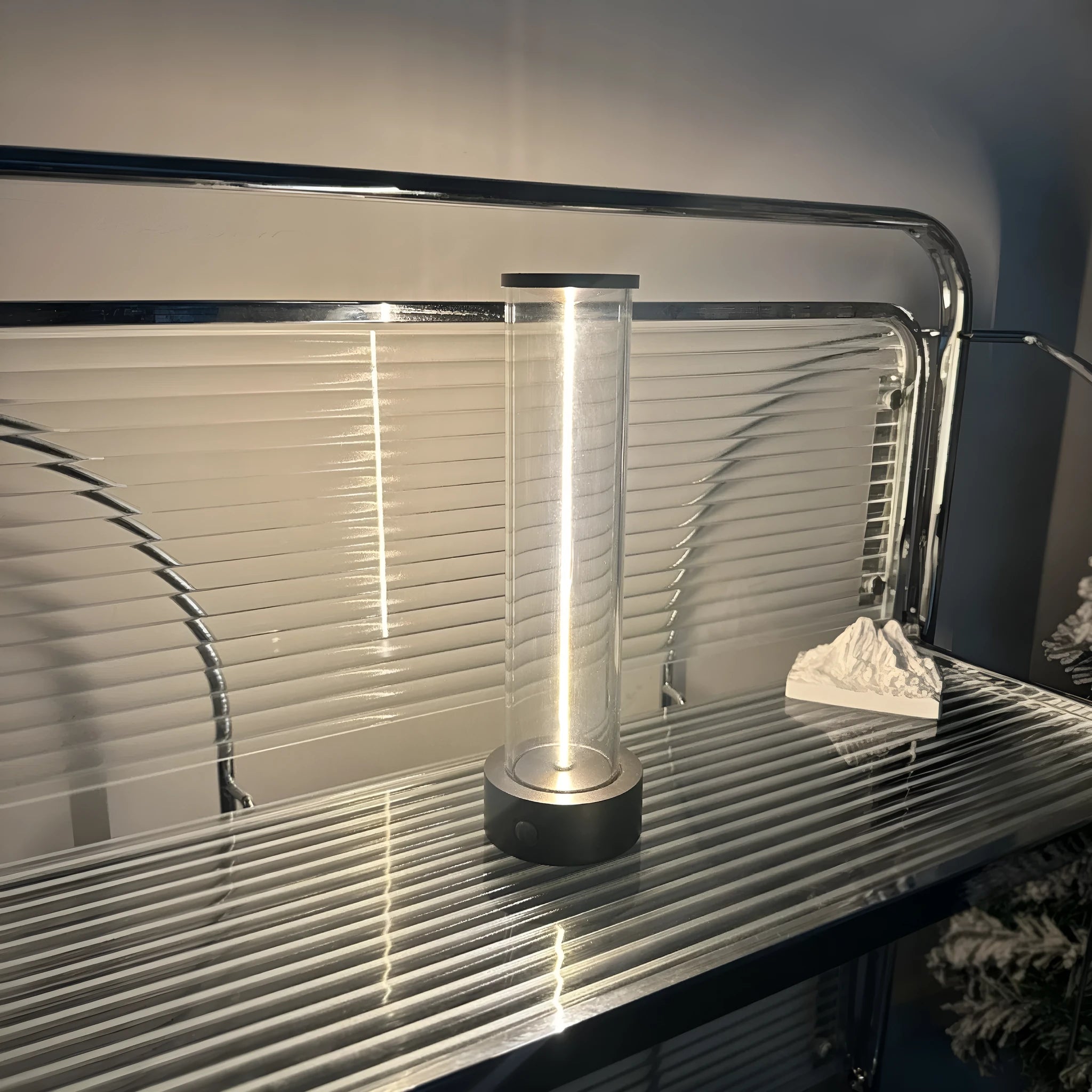 Slender white USB LED light strip with magnetic base on a metal surface