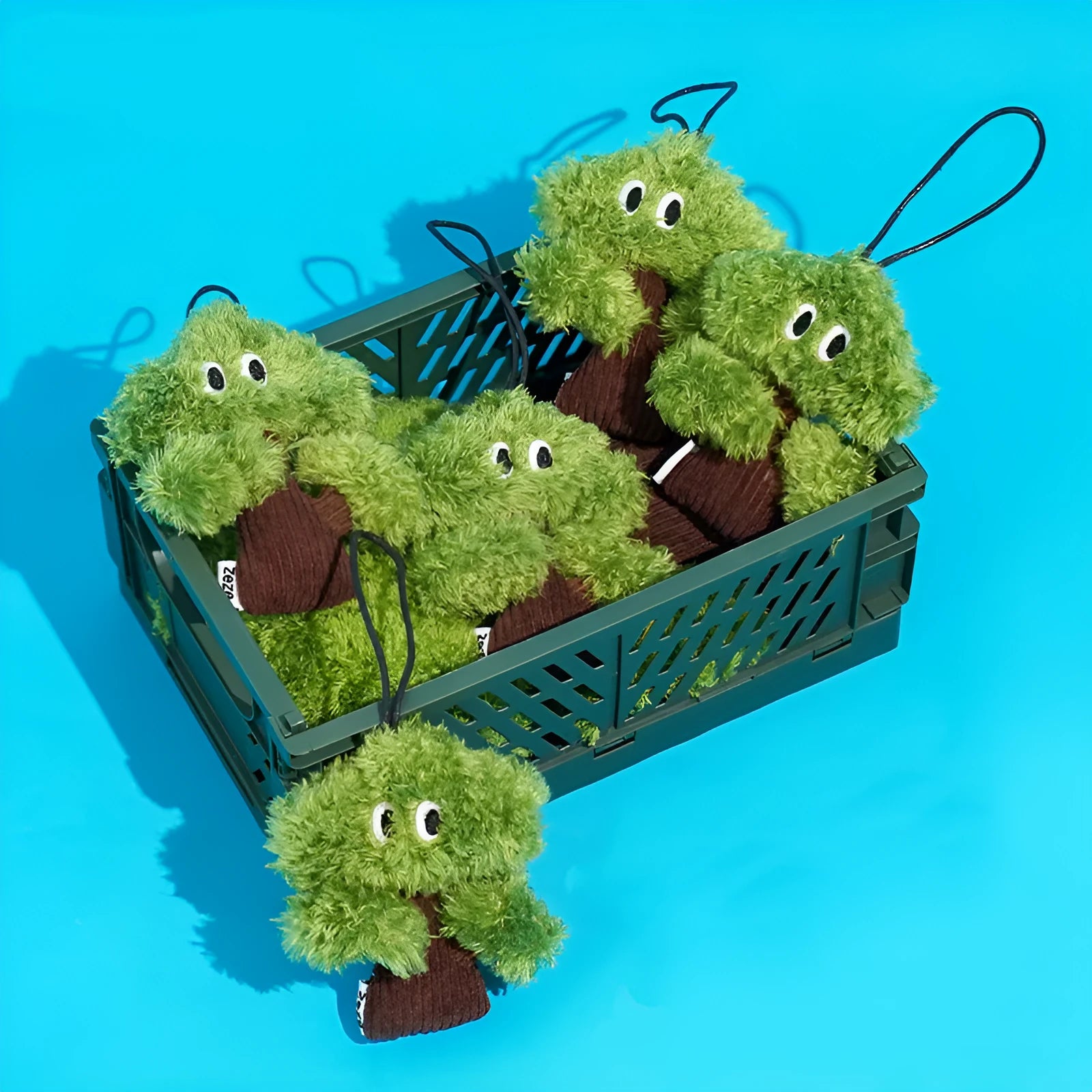 Green pine tree-shaped cat chew toy with a hanging loop, shown with size options.