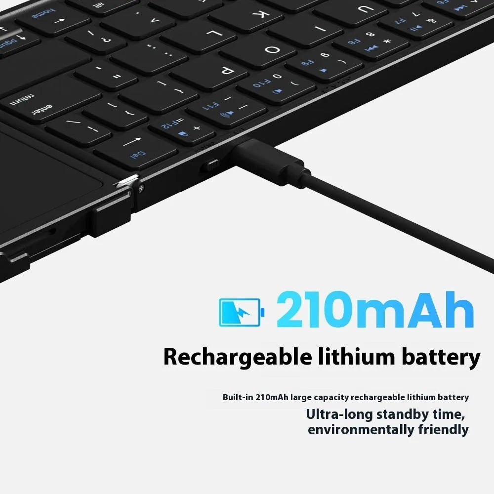 Black folding Bluetooth keyboard shown in open position next to mobile phone
