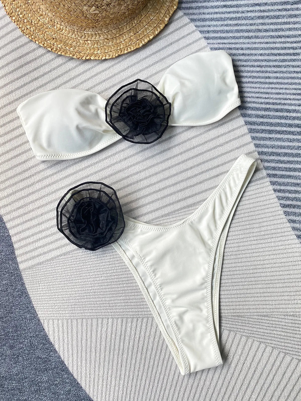 Women's black tube top bikini with a three-dimensional floral split design on the shorts.