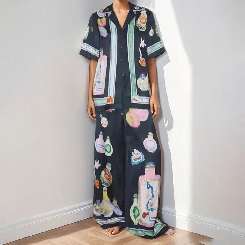 Black women's sleeve cardigan and trousers matching set with cartoon animation pattern.