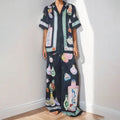 Black women's sleeve cardigan and trousers matching set with cartoon animation pattern.