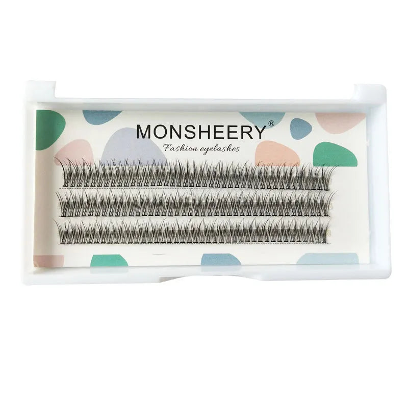 Black V-shaped fairy fishtail false eyelashes with thick segments on a clear tray.