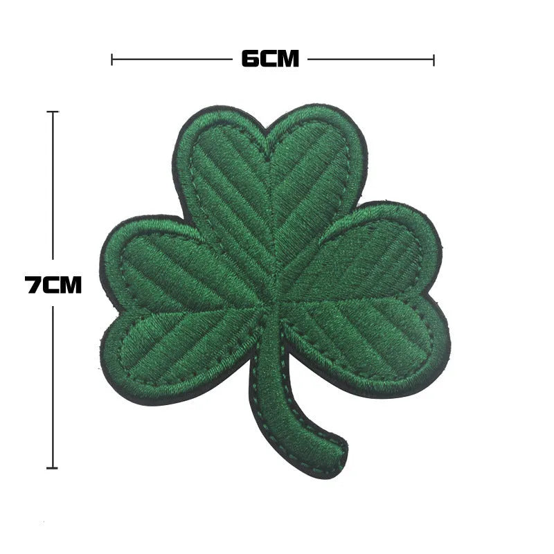 Embroidered green clover design Velcro fabric badge patch on a hook and loop strip.