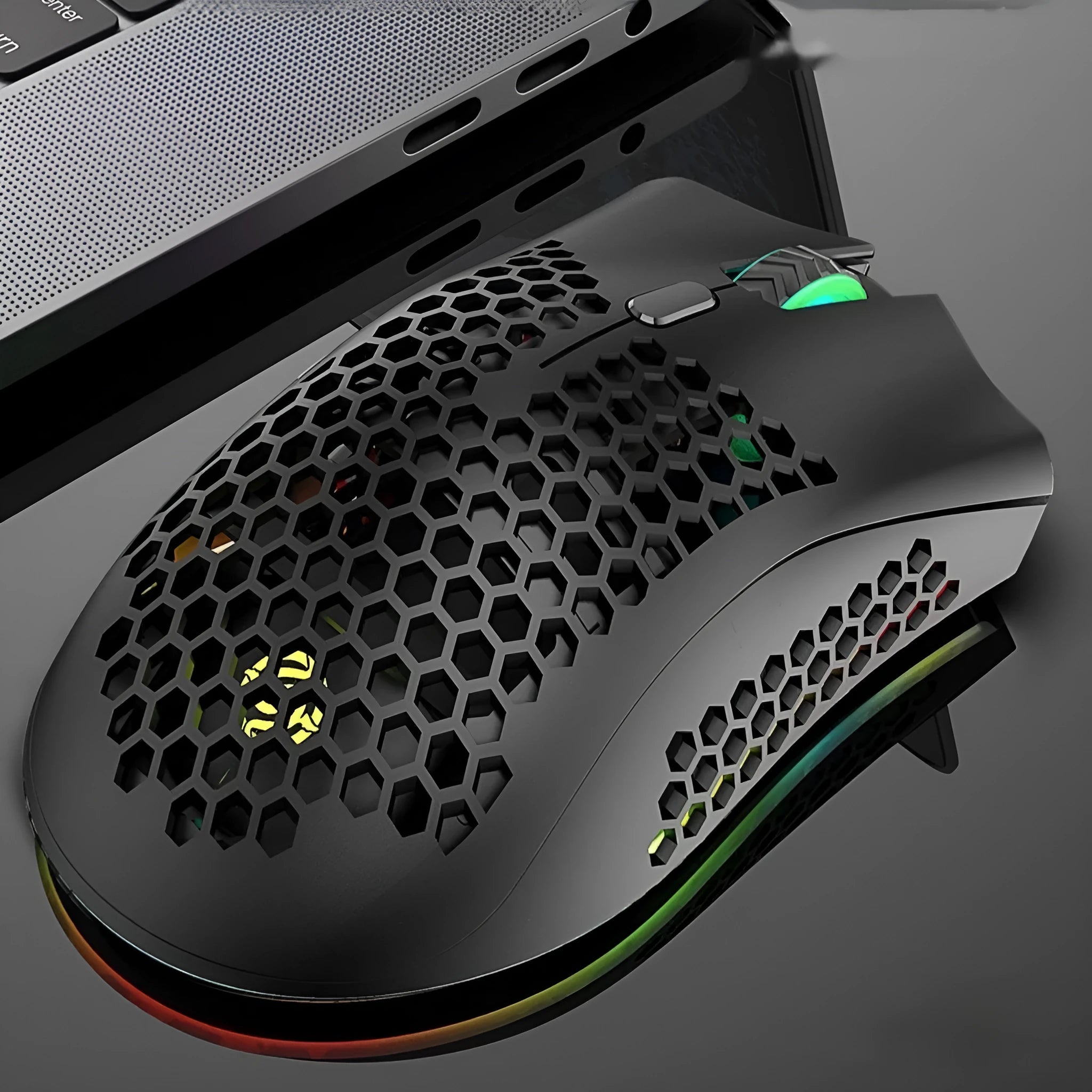 Hollow-out wireless gaming mouse with glowing light, shown in cyan colour on a desk.