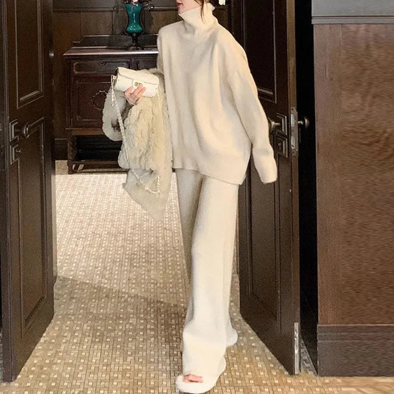 Women's casual two-piece set with an acrylic sweater and wide-leg trousers in a solid colour.