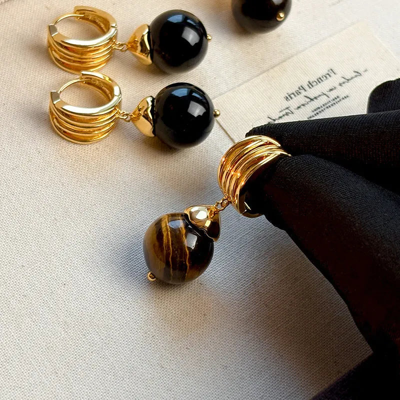 Geometric round tigereye stone earrings for women with gold plating in black and brown.