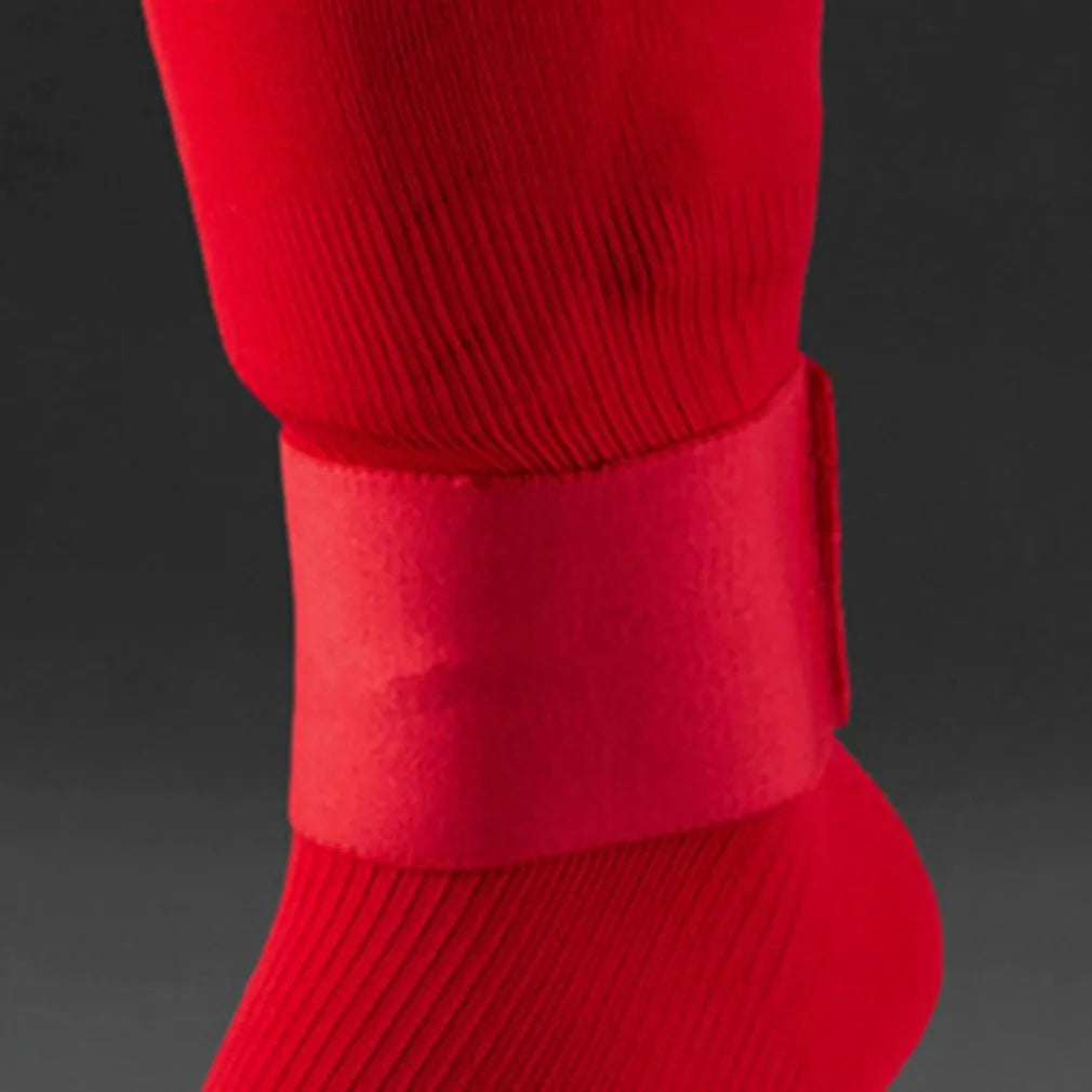 Red rubber elastic strap for securing football shin guards and sports protective pads.