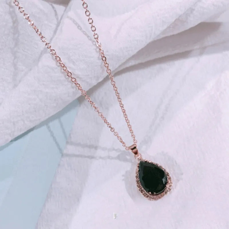 Rose gold electroplated necklace with water drop shaped geometric pendant and rhinestone detailing