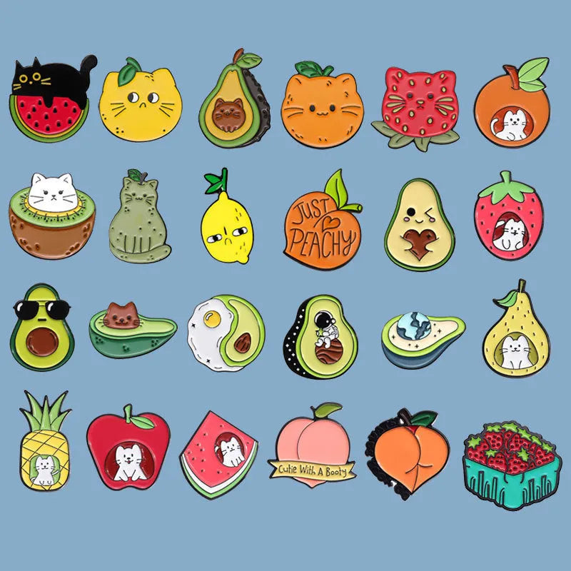 Colourful cartoon fruit shaped into a letter on a metal brooch with pin clasp.
