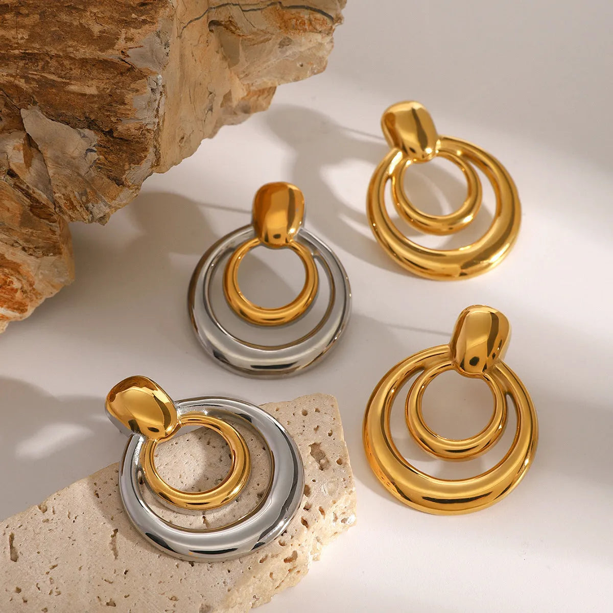 Gold round geometric stud earrings with double layer hollow construction and 18K gold electroplated finish