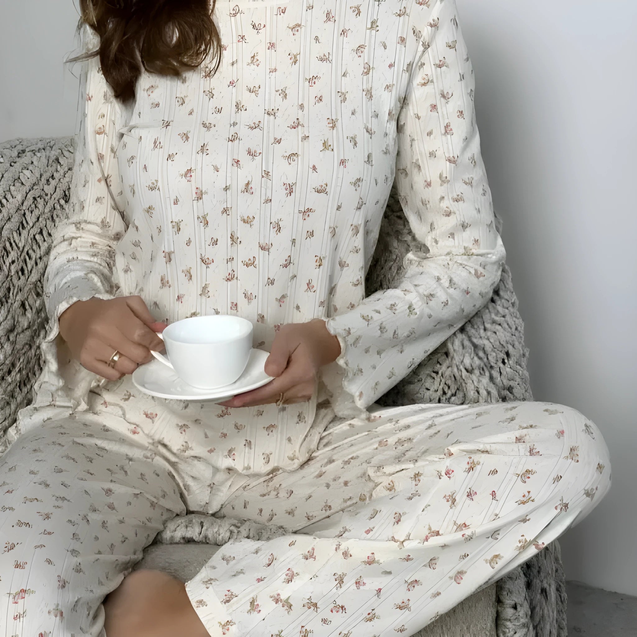 White floral print women's loungewear set with bell sleeve top and wide leg trousers.