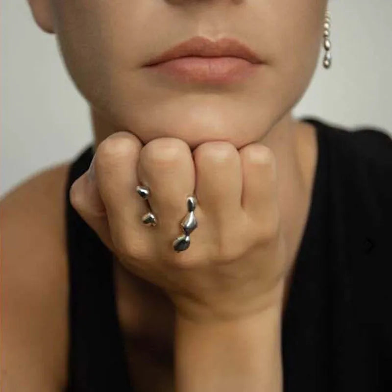 Brass opening ring with spherical details in gold or silver colour on display surface