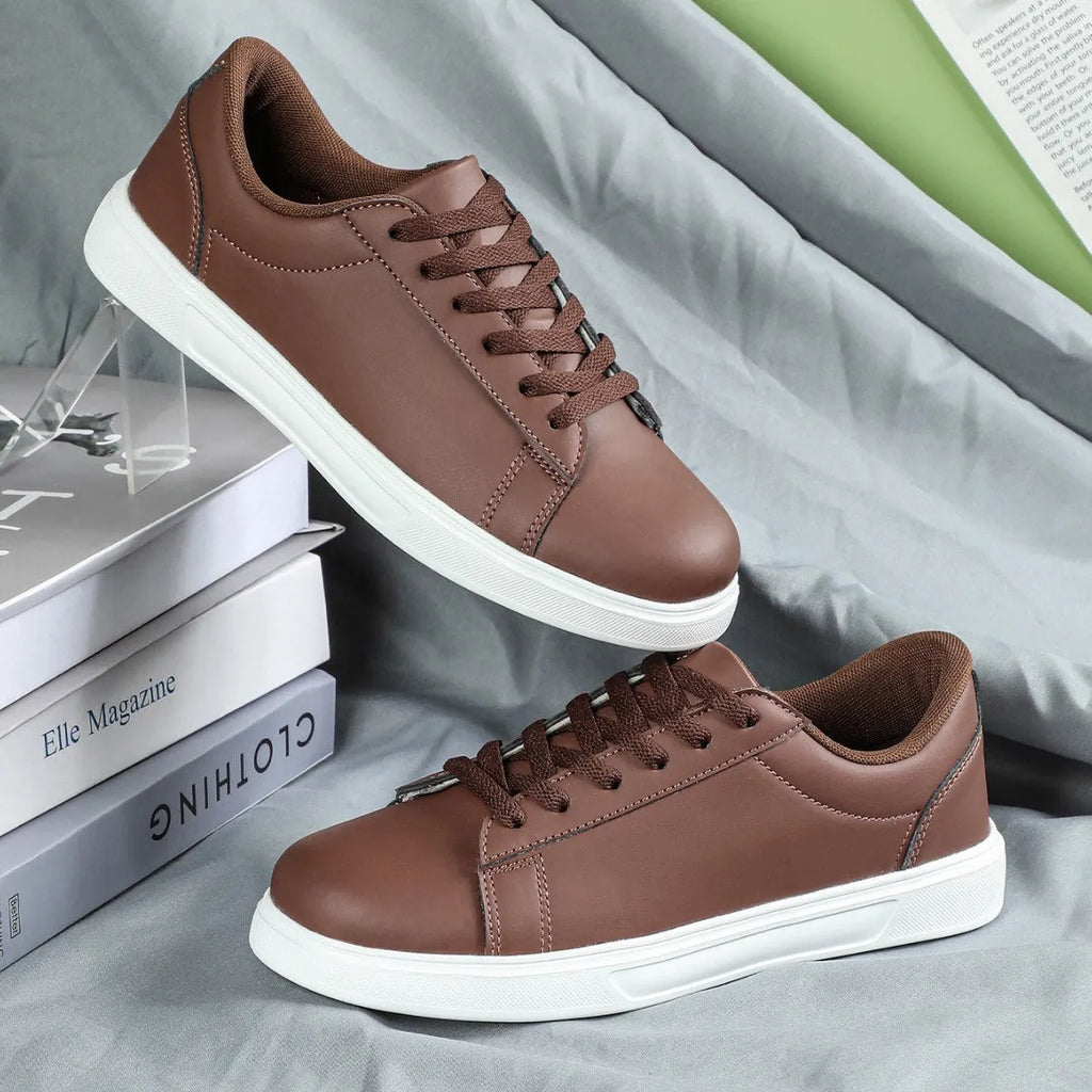 Beige brown casual platform sneakers with a cross strap and round toe on a rubber sole.