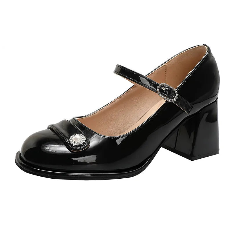 Women's black patent leather chunky heel round toe high heels with ankle buckle.