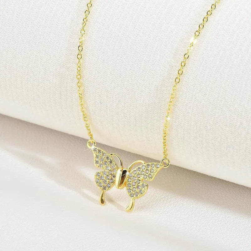 Women's clavicle necklace with magnetic butterfly pendant on twisted chain in gold finish