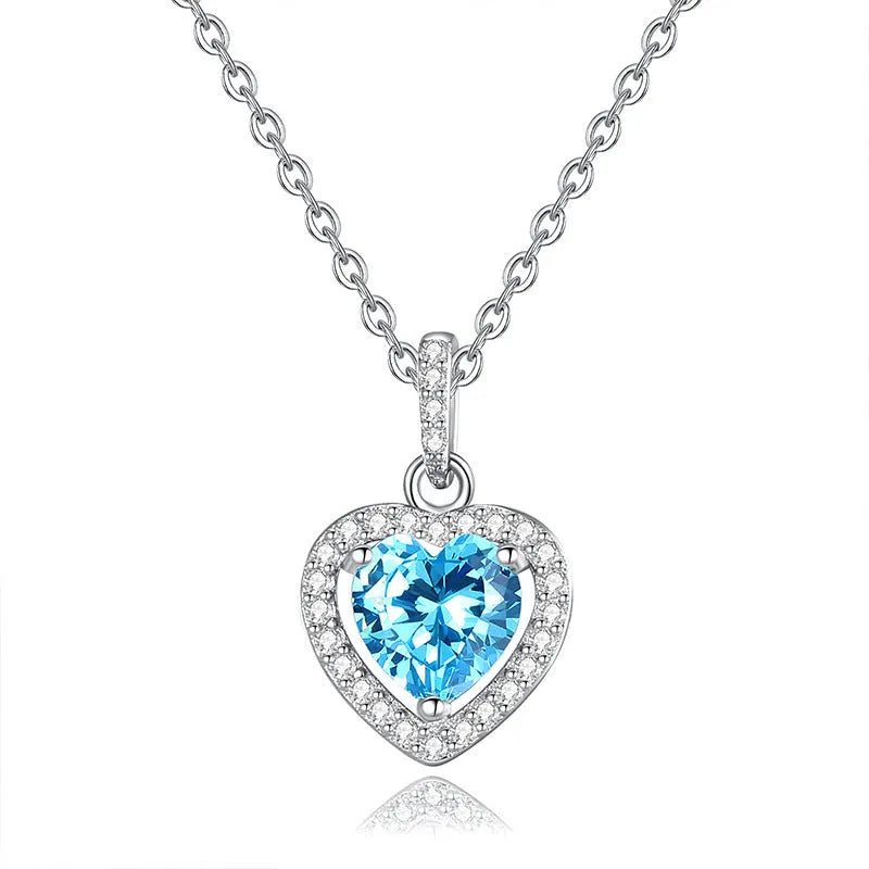 Women's sterling silver heart pendant necklace with natural gemstone on a cross chain.