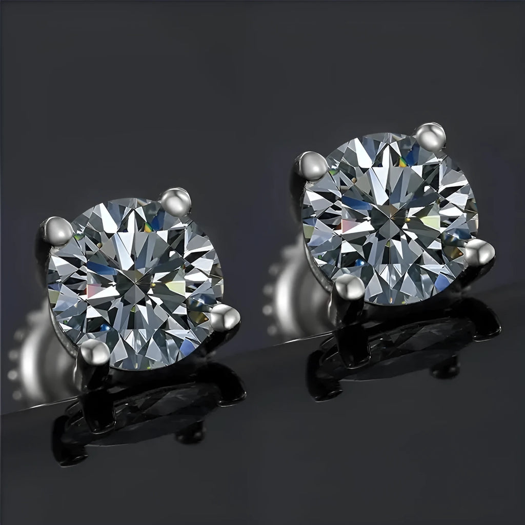 Silver geometric screw back moissanite stud earrings with four-claw setting on a black card.