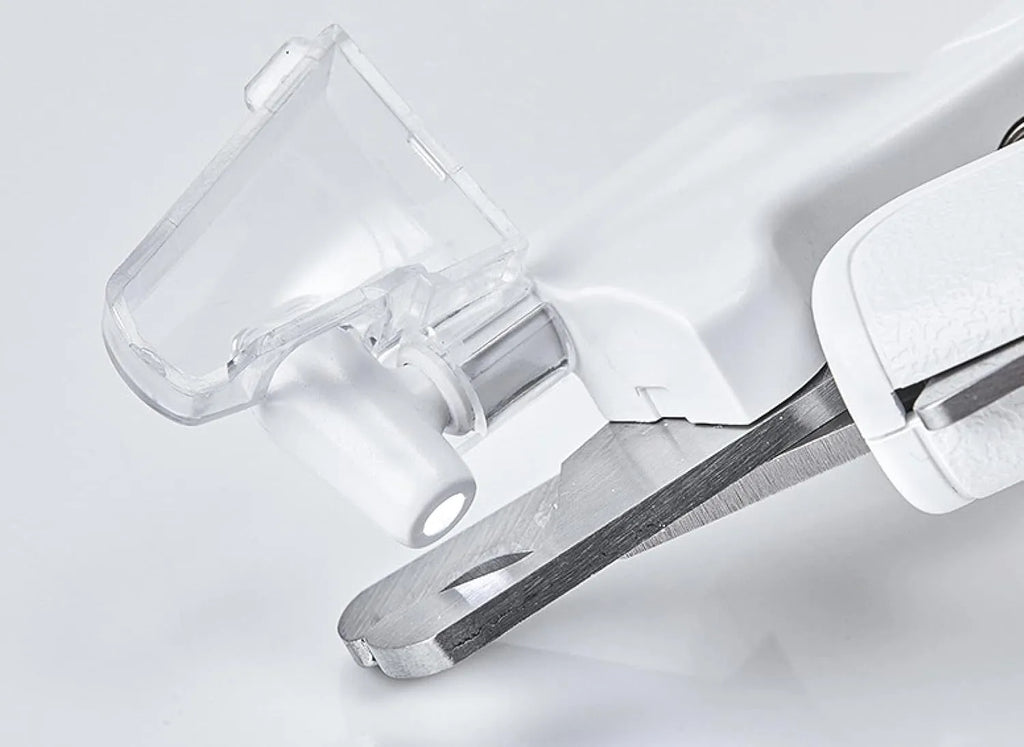 White pet nail clippers with LED light, transparent anti-splash guard, and leather-like handle on a table