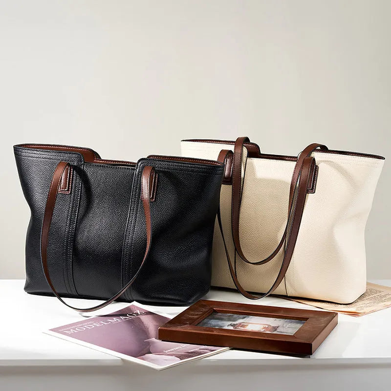 Women's black genuine leather crossbody commuter bag with square shape and multiple internal pockets.