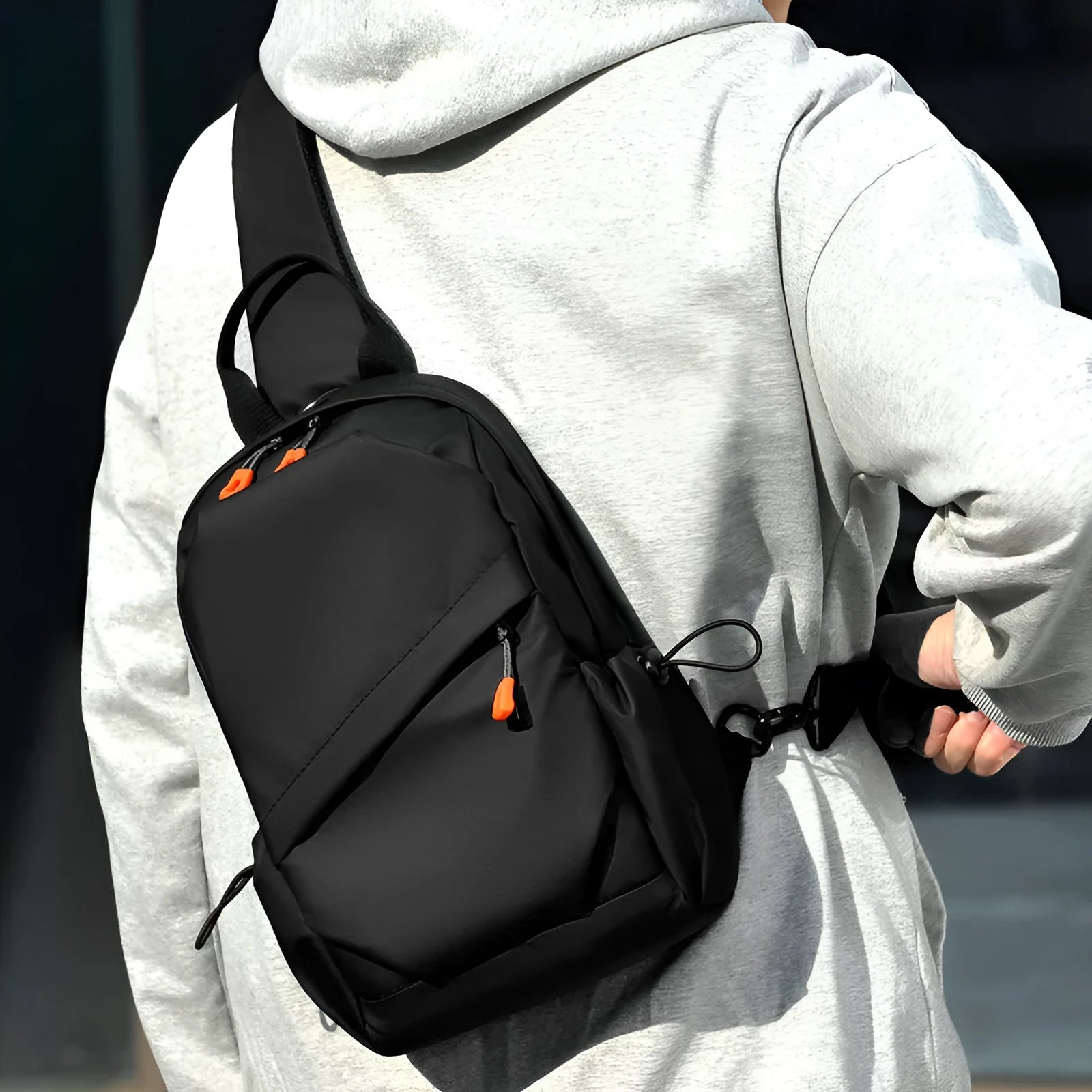 Men's black waterproof polyester crossbody bag worn across the body