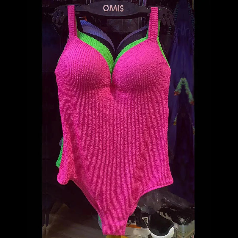 Women's black one-piece swimsuit with sunken stripe design and sleeveless cut on a mannequin.
