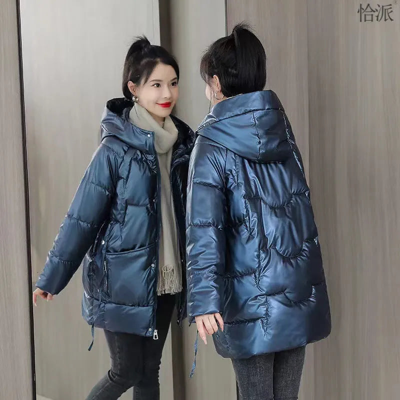 A loose-fitting, hooded winter jacket for women in a thick acrylic blend fabric, shown on a hanger.