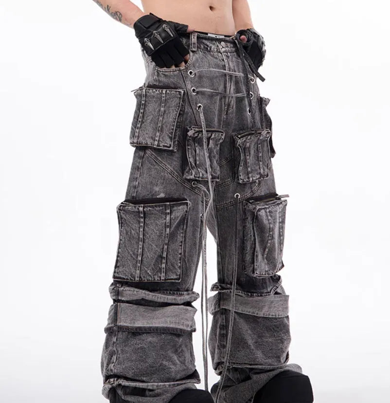 Grey cotton denim overalls with distressed finish and rope stitching on the legs.