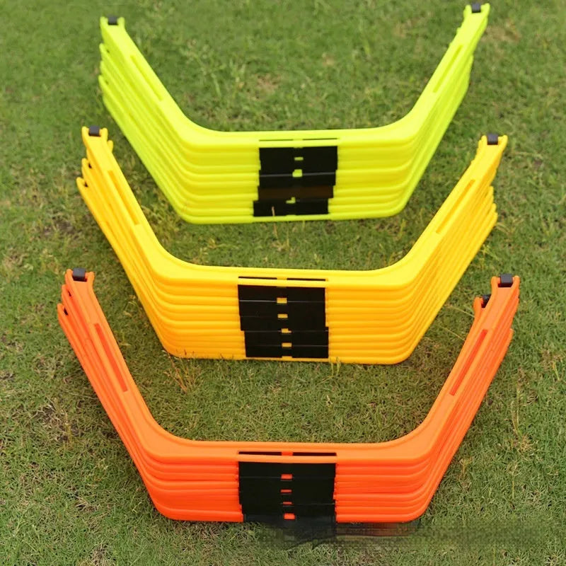 Set of six brightly coloured foldable hexagon football agility training rings on grass