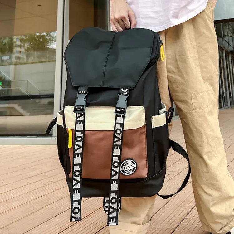 Oxford cloth student backpack shown in black, green, or red with multiple carry straps.
