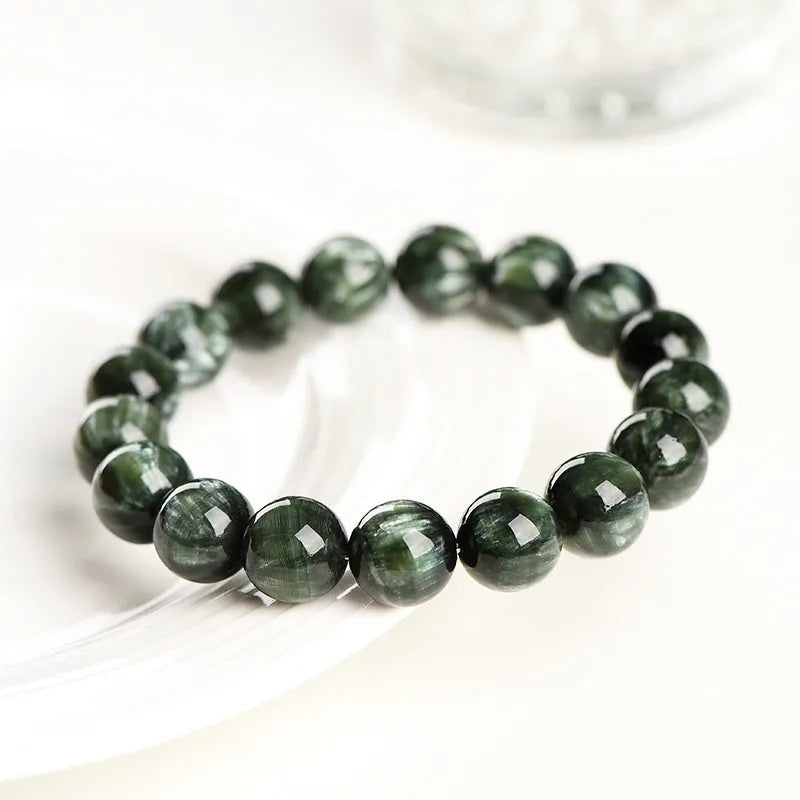 Green Dragon Crystal bracelet with Ruyi design and 8-9mm round beads on a wrist.