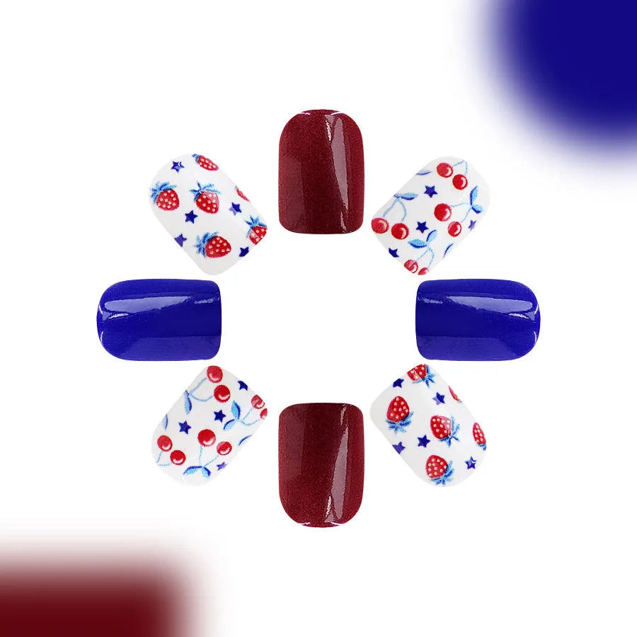 Set of 24 glossy red and blue press-on nail stickers with a strawberry pattern design for Independence Day.