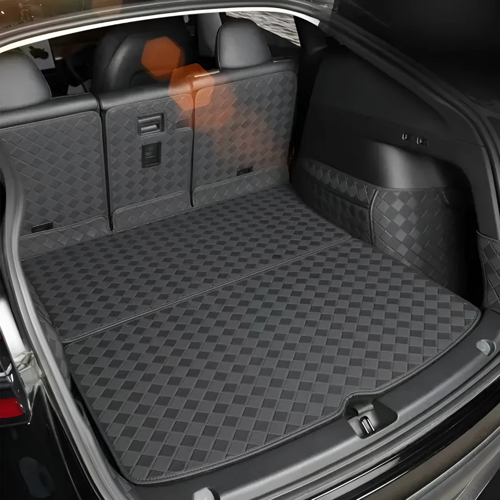 Black leather boot liner mat fitted in the luggage compartment of a Tesla Model Y