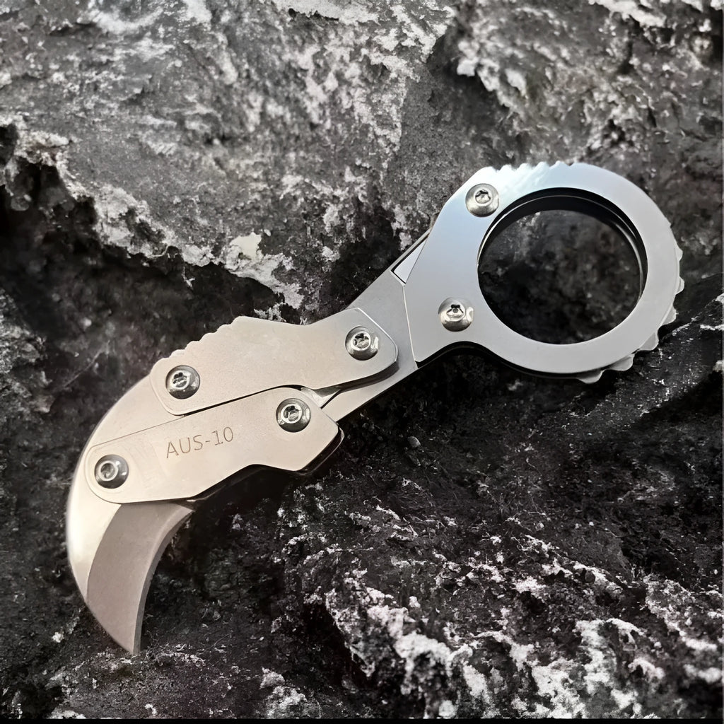Small stainless steel 420J2 folding knife with 2.6cm blade on table