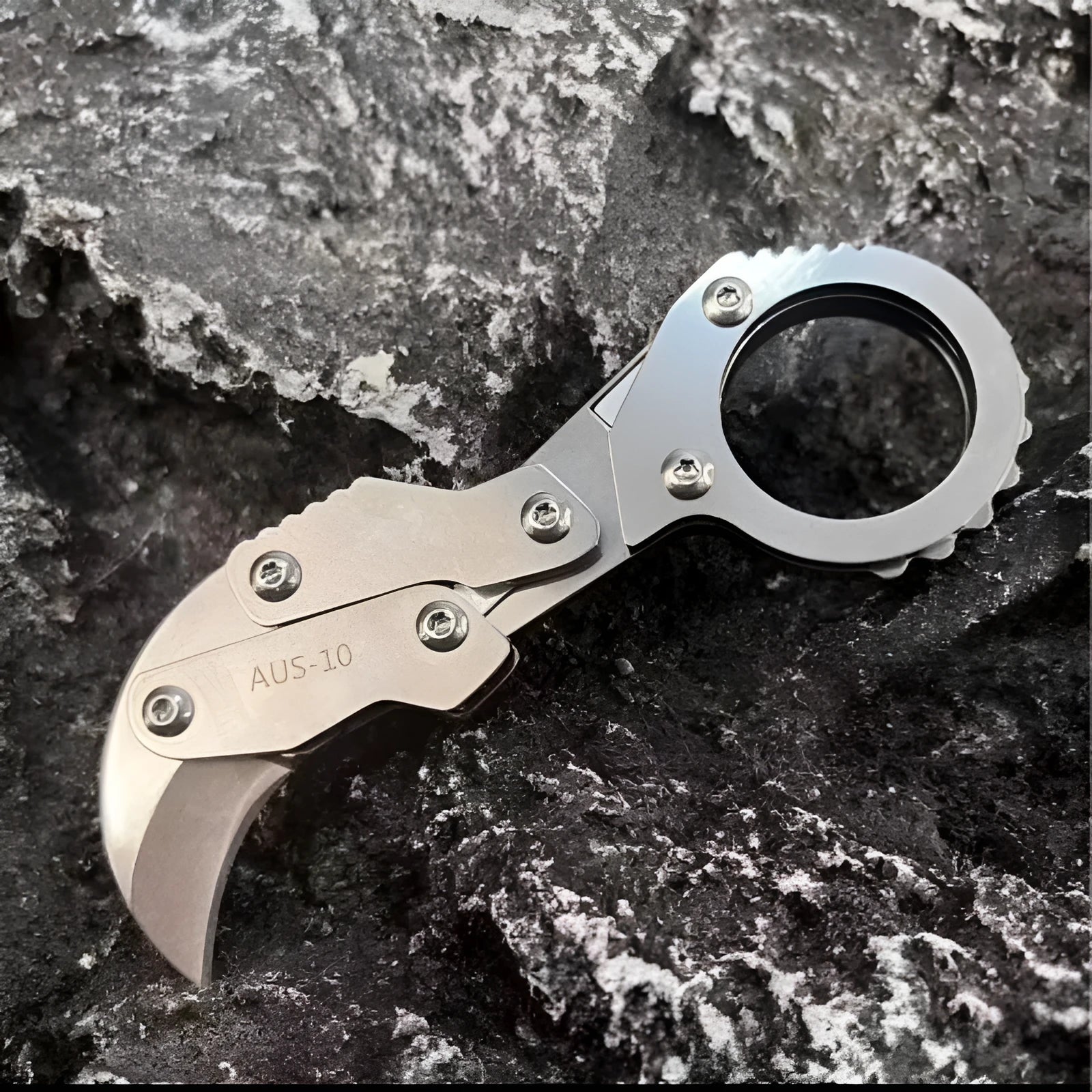 Small stainless steel 420J2 folding knife with 2.6cm blade on table