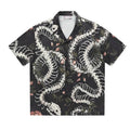Men's short sleeve Cuban collar shirt featuring a snake bone and floral printed pattern in a loose fit.