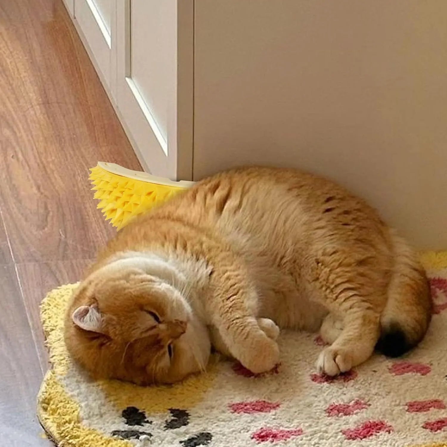Yellow durian-shaped cat corner scratcher and massage comb mounted on a wall