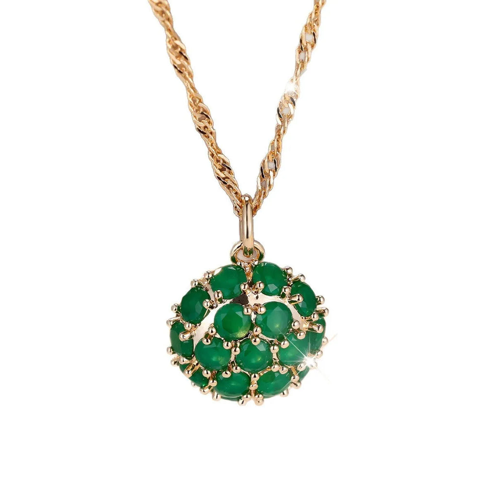 Geometric pendant necklace with emerald and diamond detailing on adjustable champagne gold chain
