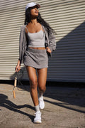 Women's blue polyester hooded jacket and matching miniskirt outfit set on a hanger.