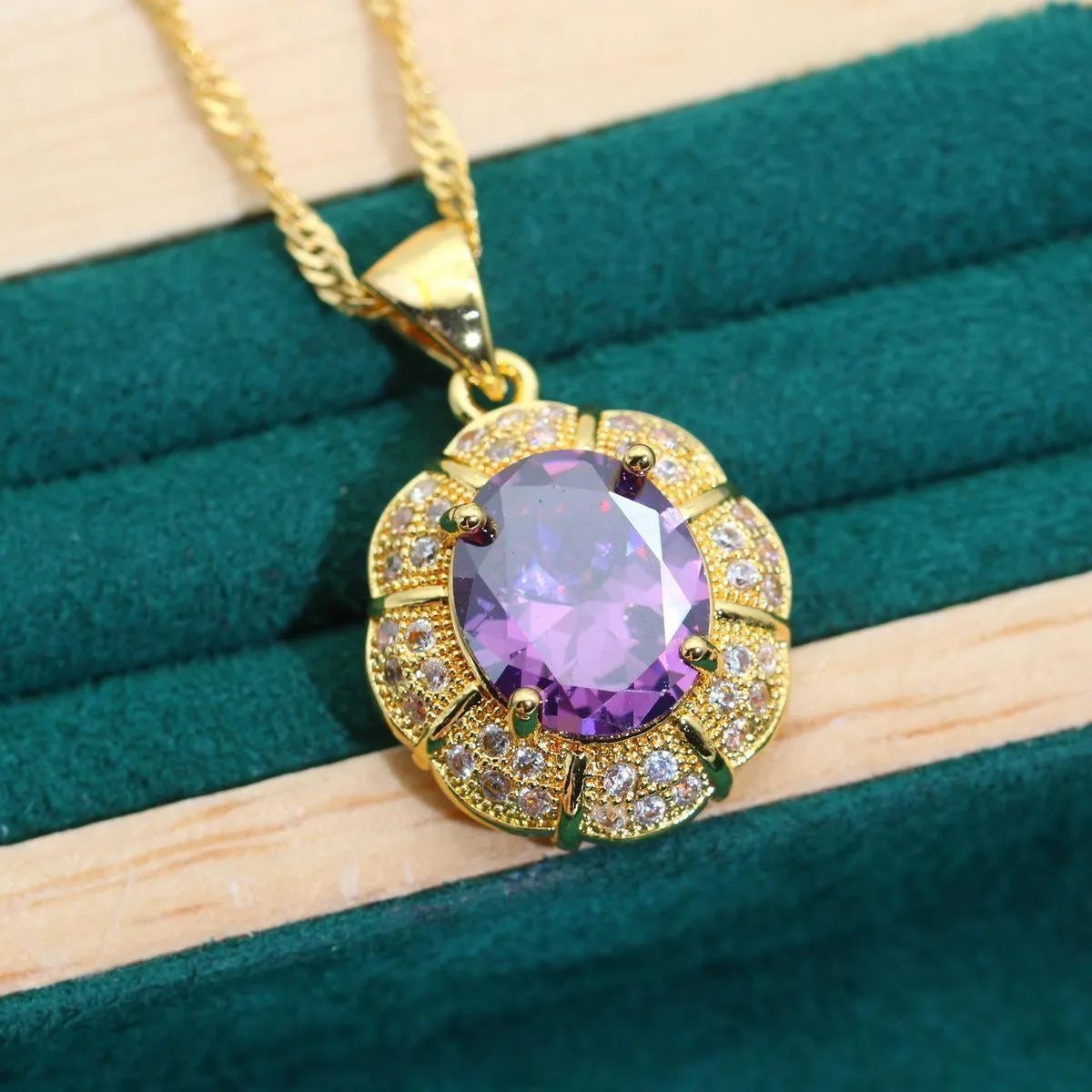 18k gold plated zircon jewellery set showing ring, earrings, bracelet and necklace in a coordinating colour.