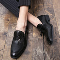 Men's black slip-on business shoes with pointed toe and tassel detail on artificial PU upper
