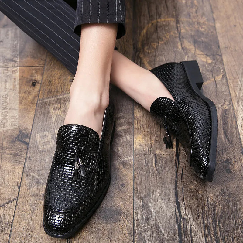 Men's black slip-on business shoes with pointed toe and tassel detail on artificial PU upper