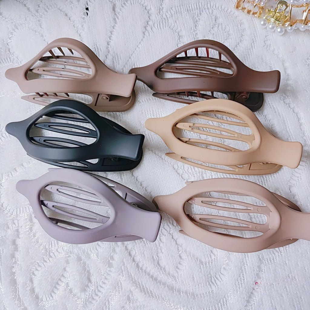 Set of six nude-coloured plastic hair clips with a quadrilateral shape and frosted grip.