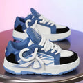 Men's white chunky sneakers with thick rubber sole, cartoon totem patterns, and lace-up front.