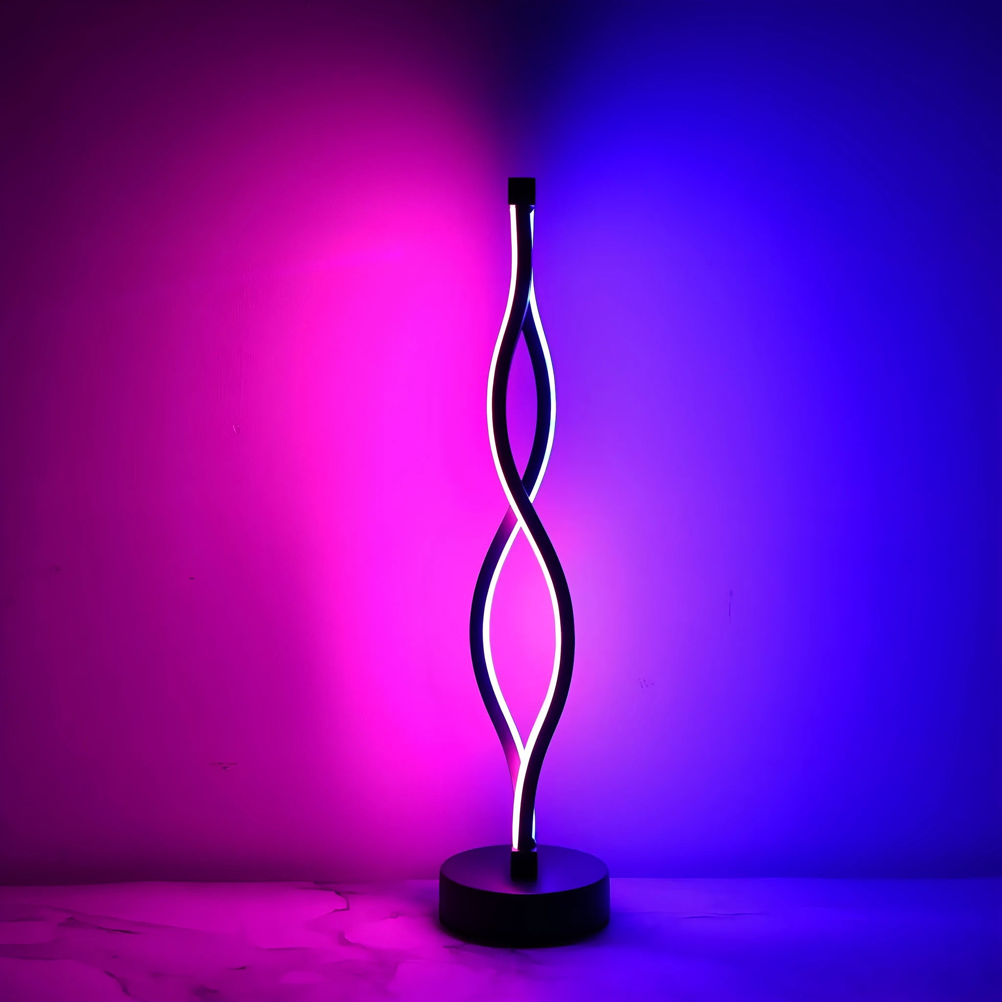 Black aluminium desk lamp on a table showing its three-colour dimming button and touch panel.