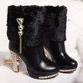 Women's black ankle boot with a chunky high heel on a white background, showing side profile.